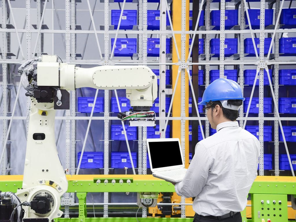 The programmer engineer control the robot for logistic warehouse